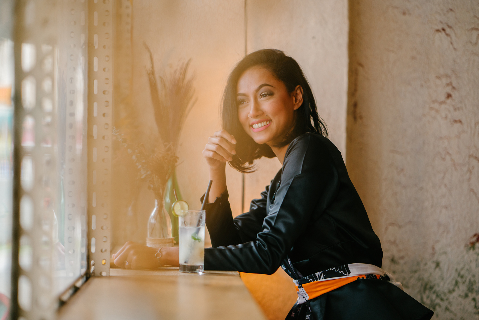 Woman Sitting on Bar Chair Near Clear Drinking Glass